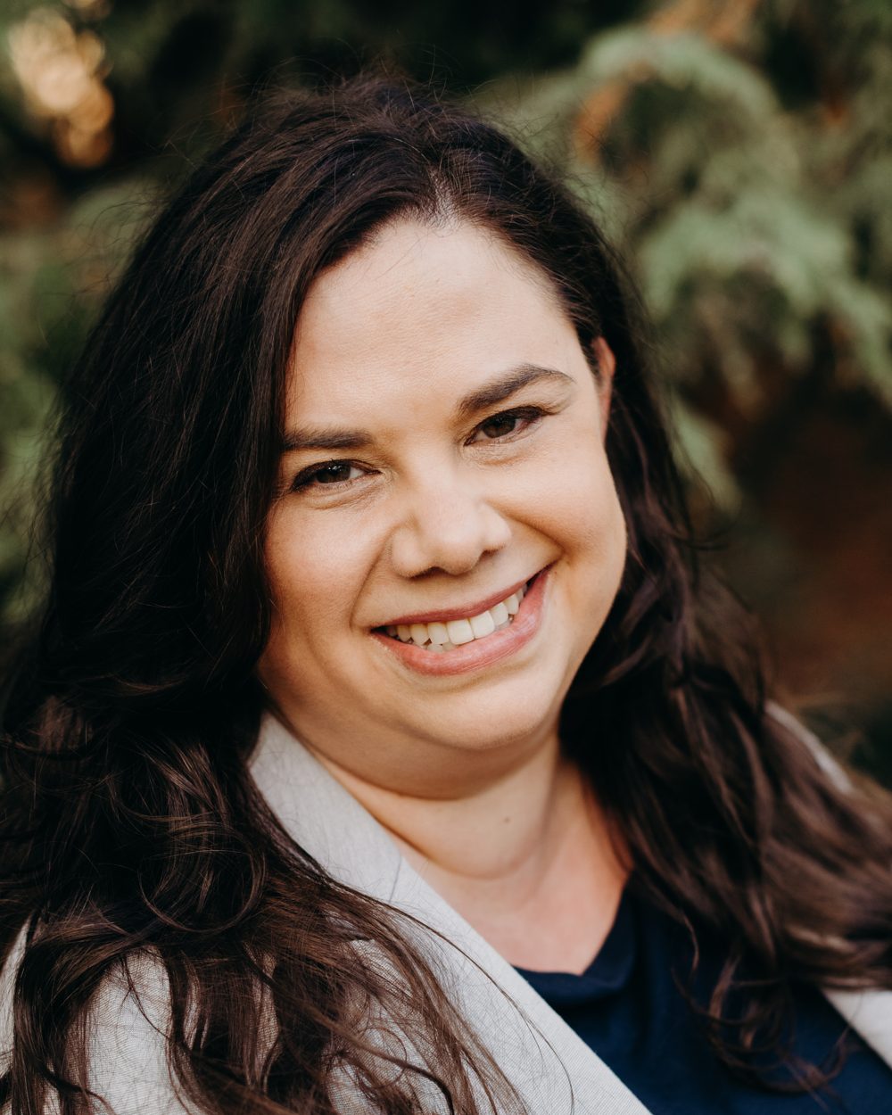 Jessica Deitchman smiling, outdoors among Fair Oaks greenery